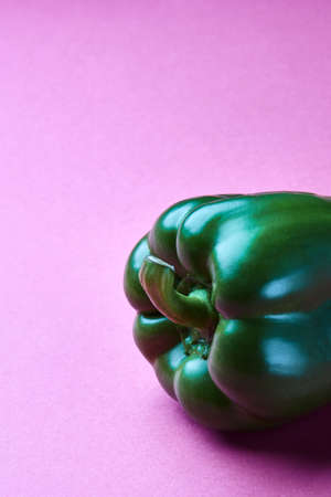 Green fresh pepper isolated on a pink background with copy spaceの写真素材
