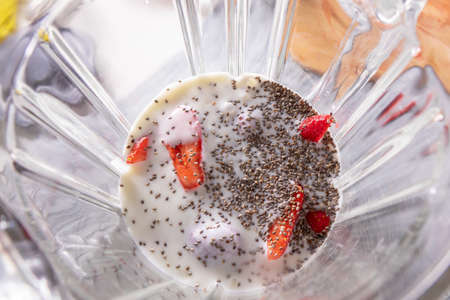 Pink smoothie in a blender with strawberries and chia seeds, view from aboveの写真素材