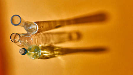 Top view of three glass empty vases on a yellow paper.の写真素材
