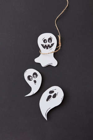 Creative Halloween card with laughing flying scary specter and ghost hanging from a rope handmade...