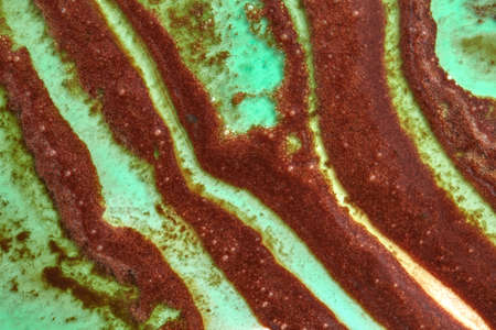 Creative geometric background with melting colorful sorbet in a green and brown tones. Top view.