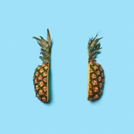 Two pieces of ripe organic pineapple on a blue background with sの写真素材