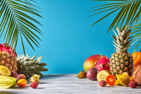 Pineapple, mango, dragon fruit, passion fruit, coconut, carambola, kumquat - frame of exotic fruits...