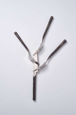 Creative pattern of vintage knife and forks on a gray background with space for text. Flat lay