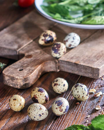 Quail eggs and greens in a plate on a wooden table. Ingredients for Making Healthy Salad