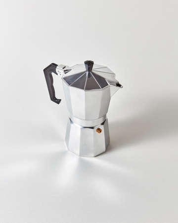 Traditional metal Italian coffee maker presented on a gray background with copy space.の写真素材