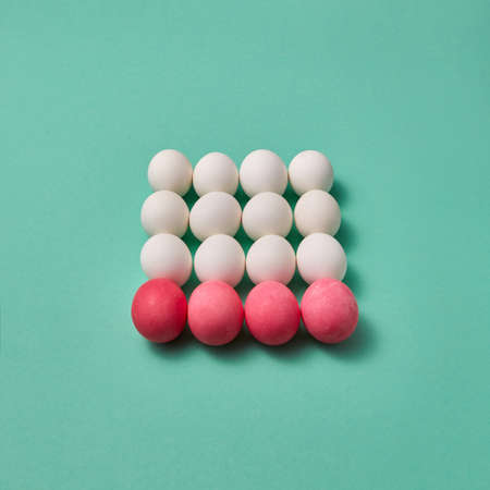 Beautiful Easter composition made of painted pink and white eggs on a green background with copy space. Billiard game concept.の写真素材