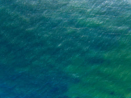 Aerial top view water surface background. Bird eye sea surface photo from drone. Turquoise ocean...