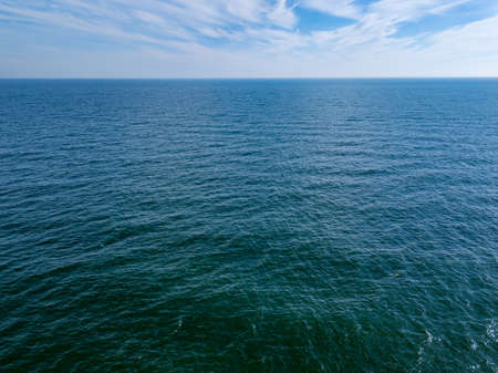 Seascape with blue sea horizon and cloudy blue sky. Aerial birds eye view from drone. Copy space. Natural backgroundの写真素材