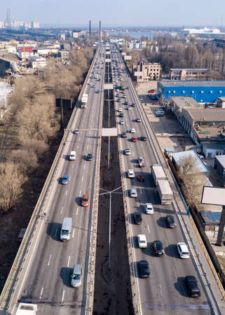 Highway with moving cars and trucks in the city Kiev, Ukraine. Aerial view from drone in a spring...