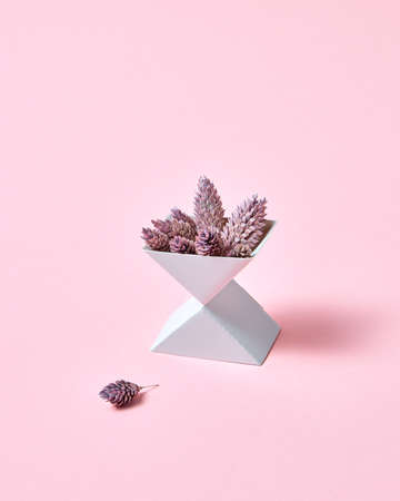 Creative composition of two cardboard boxes with cones on a pink background with space for text. Autumn layoutの写真素材
