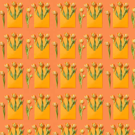 Decorative pattern with gift envelopes of tulips flowers on an orange.の写真素材