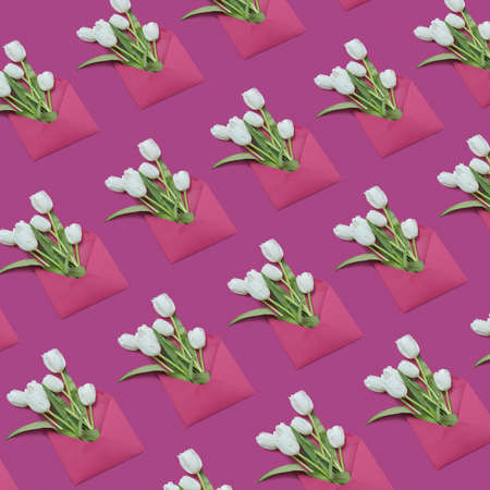 Decorative background with gift envelopes of tulips flowers on a magenta.の写真素材