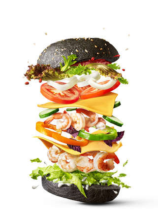 Flying burger with shrimp and fresh vegetables on a white background.の写真素材