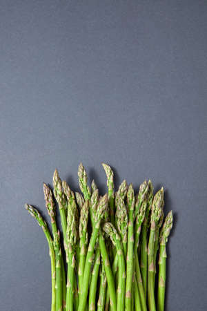 Heap of fresh natural asparagus on a gray background.の写真素材