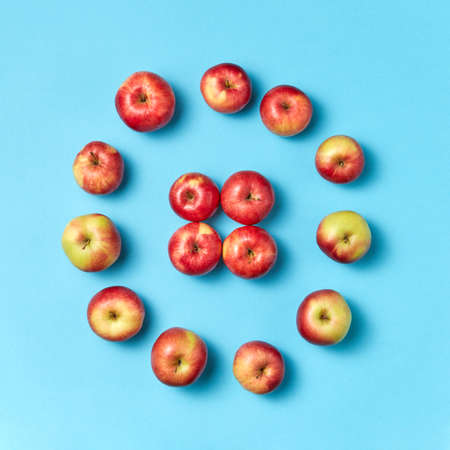 Round apples frame on a blue background.の写真素材