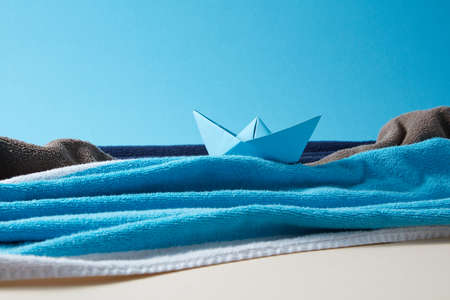 Seascape made from terry towels with paper boat and rocks.の写真素材