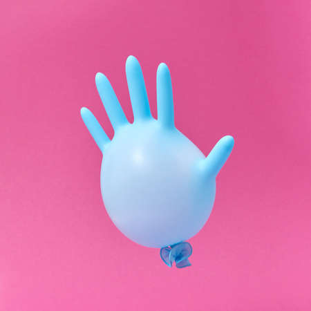 Blue latex glove balloon on a hot pink background.