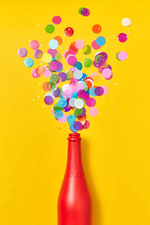 Colorful confetti as a bubble foam from painted red wine bottle.の写真素材