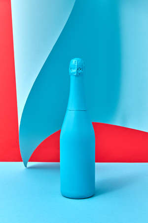 Decorative painted blue wine bottle mock up on a duotone wavy background.の写真素材