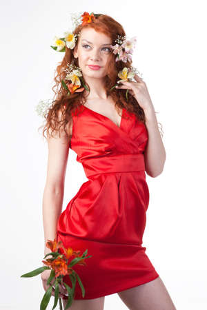 Portrait of woman in red dress with spring flowers on whiteの写真素材