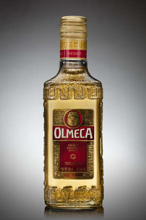 UKRAINE, KYIV-DECEMBER 12, 2012. Olmeca Tequila Cold bottle from Jalisco, Mexico on a gray background.のeditorial素材