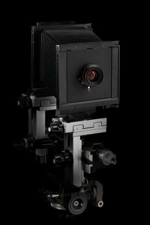 Old retro photo camera on a black background.の写真素材