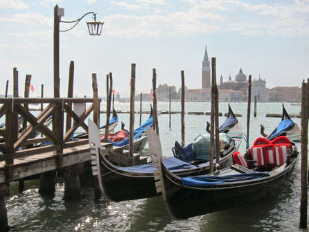 Traditional italian gondolas parking near berth.の写真素材