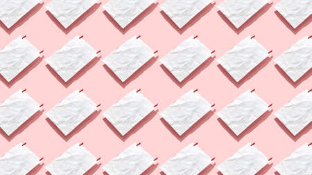 White paper pattern from blank crumpled sheets with small clothespins on a pastel pink background,...