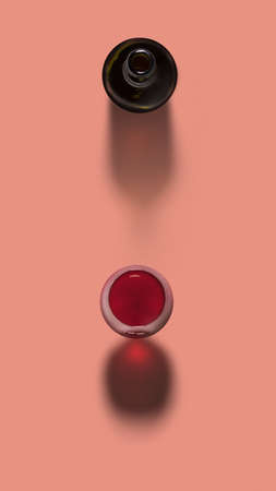 Top view above opened bottle and glass of red wine on a pastel coral background with soft dark...