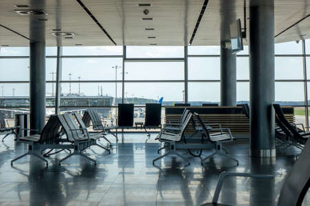 Empty hall at airport with comfortable chairs for waiting departure. Travel and transportation concept.の写真素材