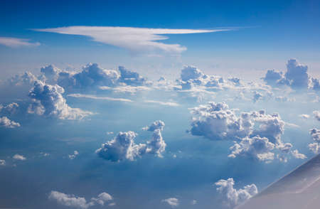Part of plane wing on a background of blue cloudy sky.の写真素材