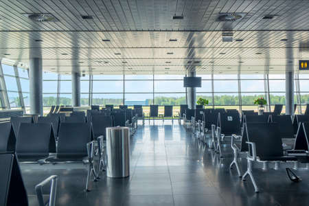 Modern airport waiting hall interior with empty chairs.の写真素材