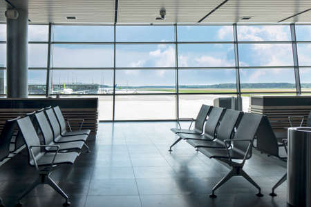 Empty chairs at waiting area in the airport terminal.の写真素材