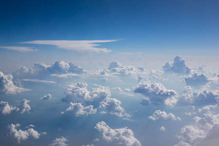 Blue clear sky with white cumulus clouds.の写真素材