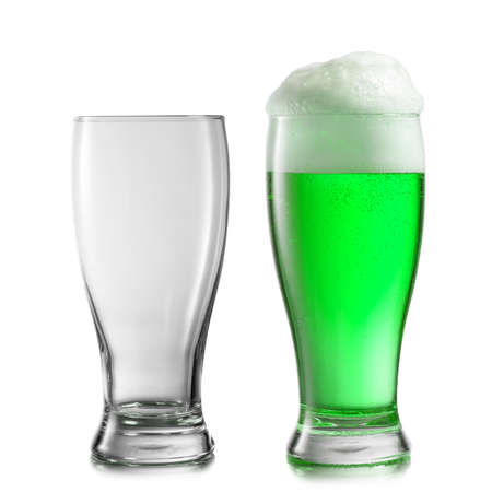 Composition from two glasses empty and filled fresh natural green beer drink with thick foam on a white background, copy space. Happy St.Patrick 's Day concept.の写真素材