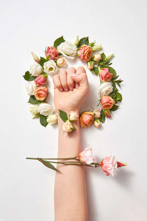 Fresh natural flowers wreath with females hand.の写真素材