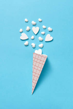 Valentines card with paper cone of white plaster hearts.の写真素材