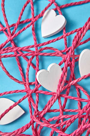 Valentines card with red rope and white hearts.の写真素材