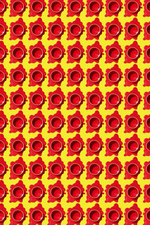 Vertical pattern of spilled paint puddles with red cans.