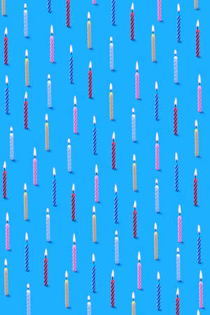 Vertical background from pattern of burning candles for cake.の写真素材