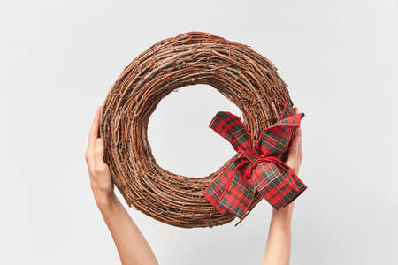 Handcraft round wreath from twigs in the womans hands.の写真素材