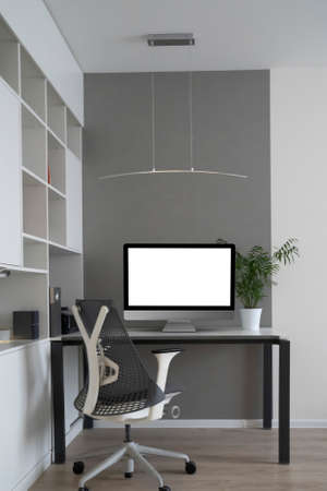Home working place with modern desk and mock-up computer monitor.の写真素材