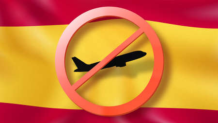 Warning sign with crossed out plane on the background of Spanish flag.の写真素材