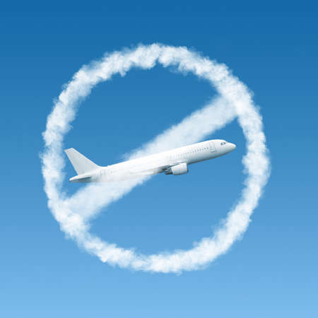 Warning sign from clouds with crossed out plane.の写真素材