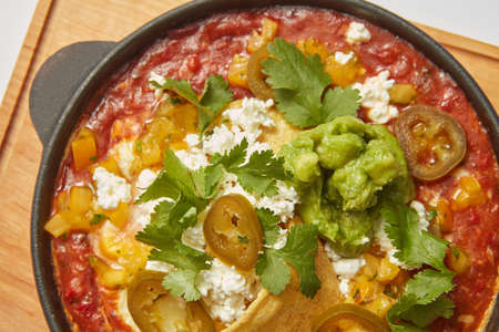 Close up view of Shakshuka dish in a pan with spicy sauce from tomatoes.の写真素材