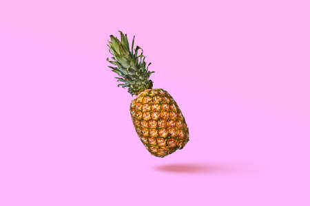 Pattern of slices and whole tropical pineapple fruit on a blue background with space for text. Flat layの写真素材