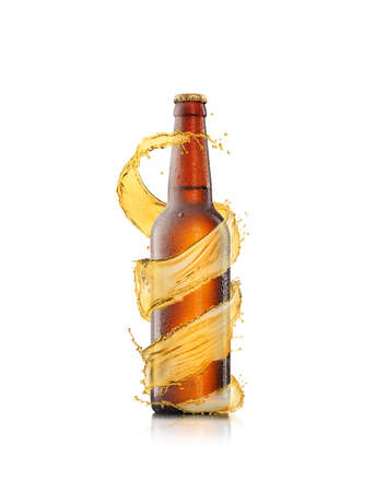 Beer bottle with water drops and creative spiral splash around brown bottle on a white background with copy space. Refreshing alcohol drinks.の写真素材