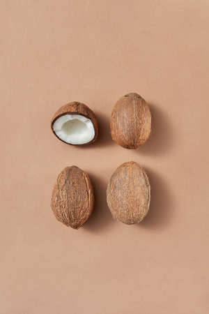 Fruit set from fresh ripe coconuts on a light brown background.
