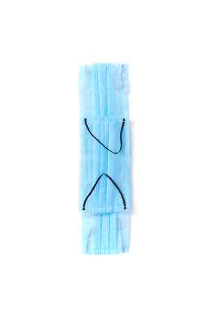 Capital letter I handmade from medical antibacterial protective blue face masks on a white...